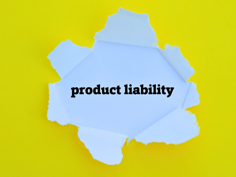 yellow background ripped open with "product liability" printed in the middle