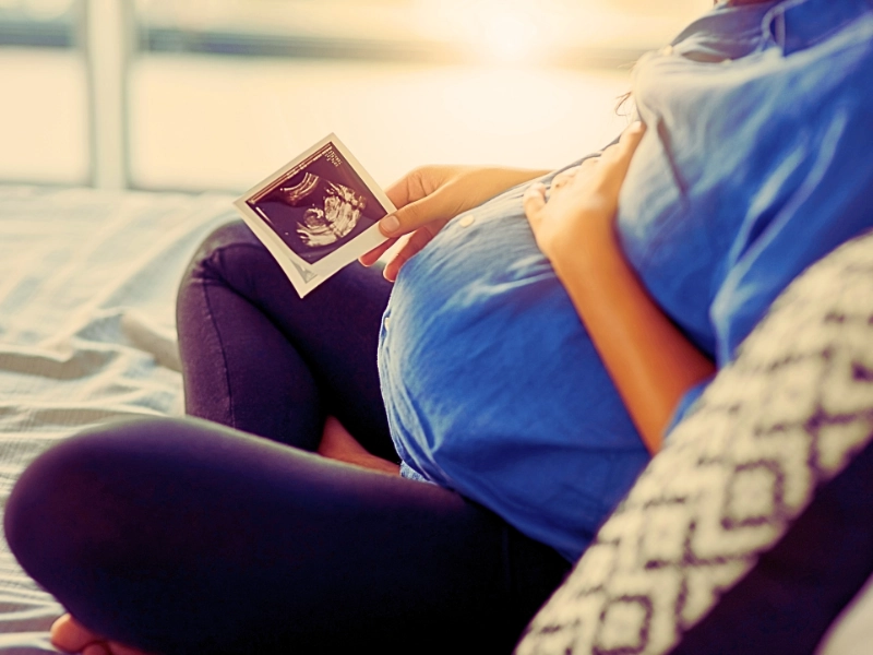 Closeup shot of an unrecognizable pregnant woman holding an ultrasound scan. 1190394881