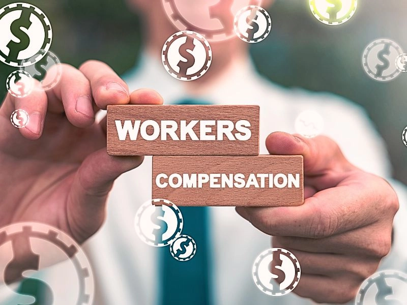 Man holding workers compensation blocks with dollar signs.
