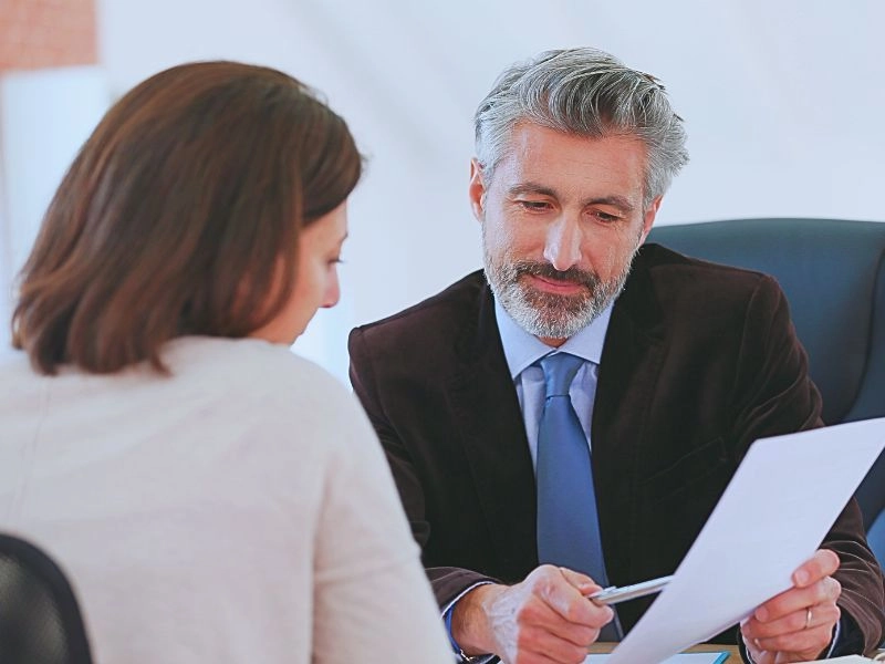 Attorney meeting client in office.