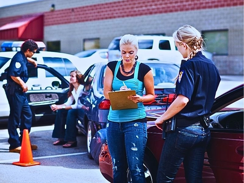Two police officers responding to a traffic accident involving two young women.
