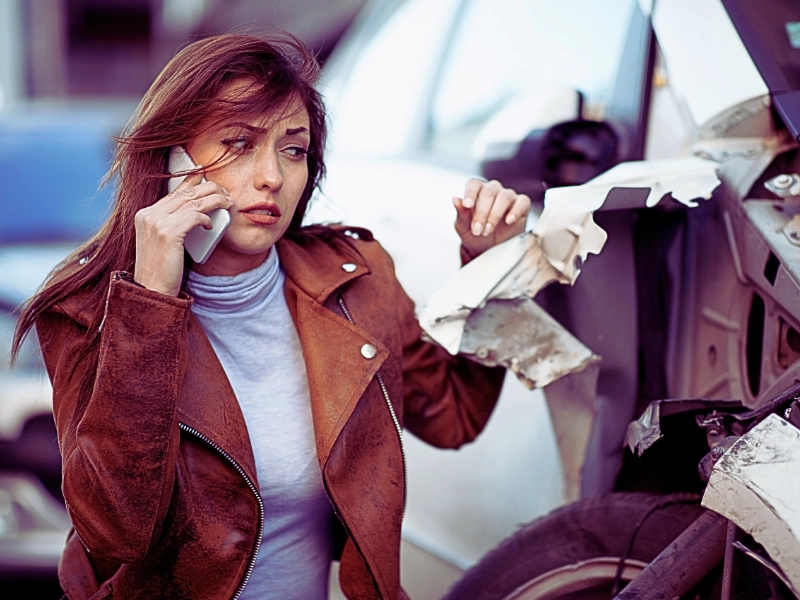 Woman on the phone after a car crash.