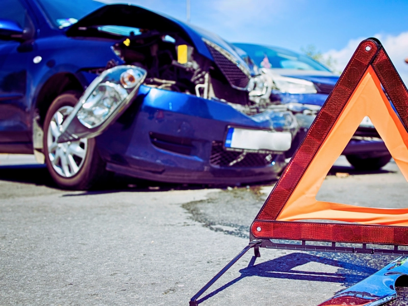 Car accident. Road disaster. Vehicle collision. Warning triangle for traffic and smashed cars. car accident lawyer deal with insurance companies