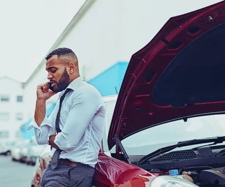 Man calling roadside assistance after breaking down. are car accident lawyers worth it