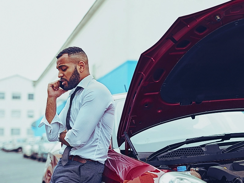 Man calling roadside assistance after breaking down. are car accident lawyers worth it