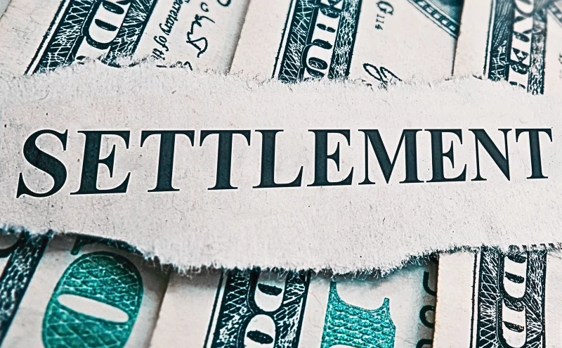 Should You Accept a Quick Settlement Offer? Why Patience Pays Off in Personal Injury Cases 1 Settlement newspaper headline on money. Quick Settlement Offer