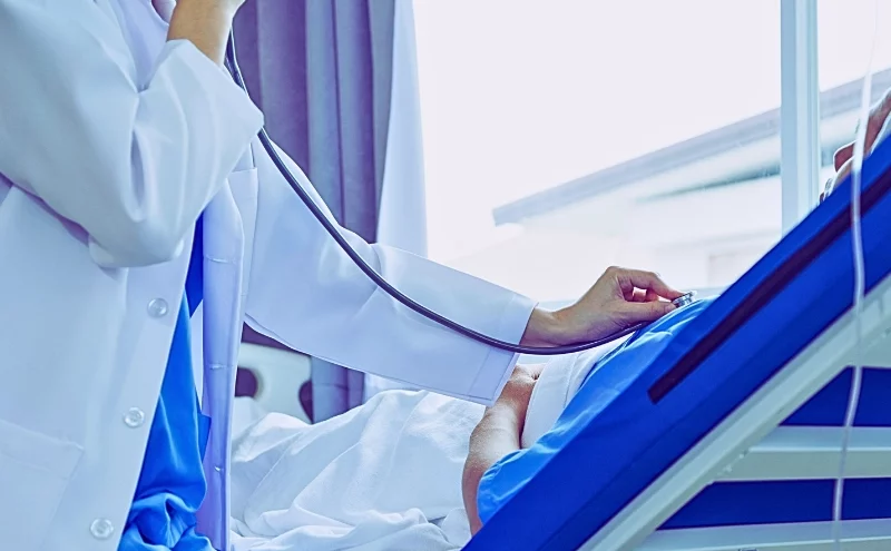 How a Delayed Diagnosis Could Cost You More Than Just Your Health 1 Female doctor listening to the patient's breathing using her stethoscope. delayed diagnosis could cost you