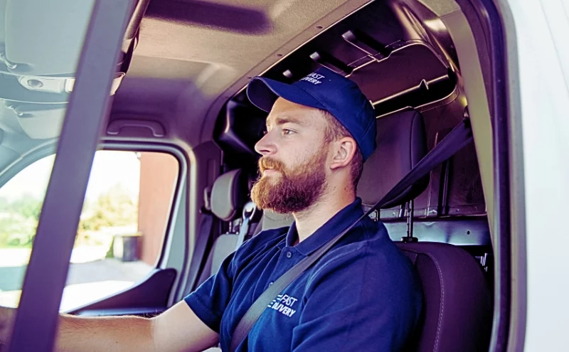 Delivery man sitting in a delivery van. delivery driver accidents