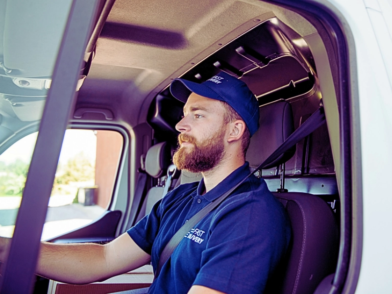 Delivery man sitting in a delivery van. delivery driver accidents