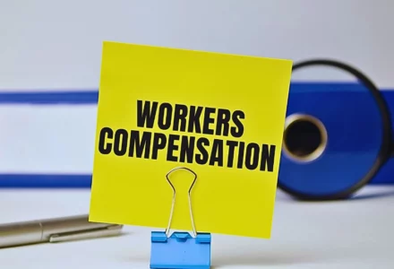 Workers compensation on yellow sticker and blue file folder. Workers’ Comp Claim with a Pre-Existing Injury