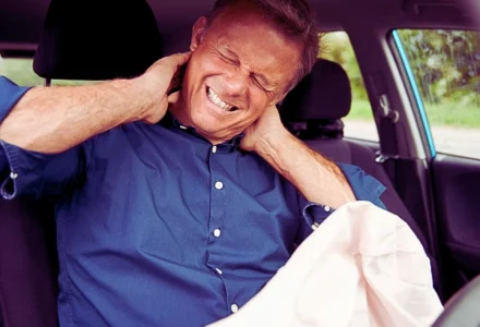 Male Motorist With Whiplash Injury In Car Crash With Airbag Deployed. Car Accidents While On the Job