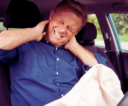 Male Motorist With Whiplash Injury In Car Crash With Airbag Deployed. Car Accidents While On the Job
