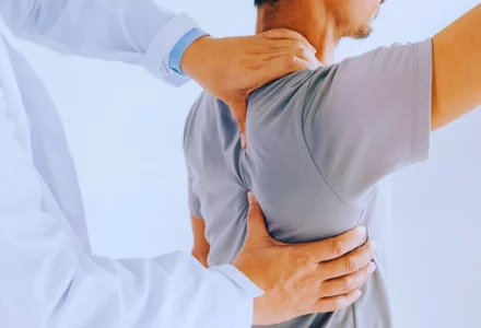 Physiotherapist doing healing treatment on man's back. Independent Medical Exams