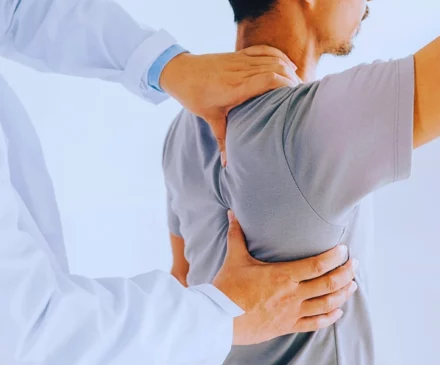 Test New 12 Physiotherapist doing healing treatment on man's back. Independent Medical Exams