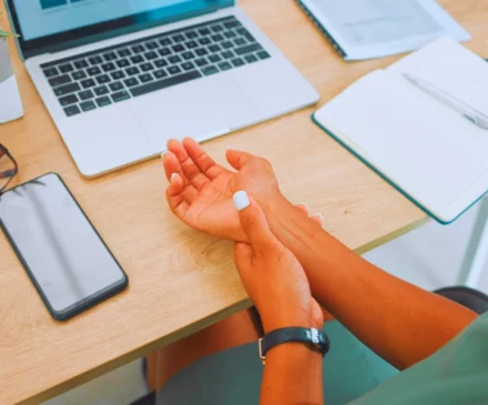 Test New 18 Wrist, arm and pain by laptop desk of employee worker suffering from carpal tunnel. Repetitive Stress Injuries