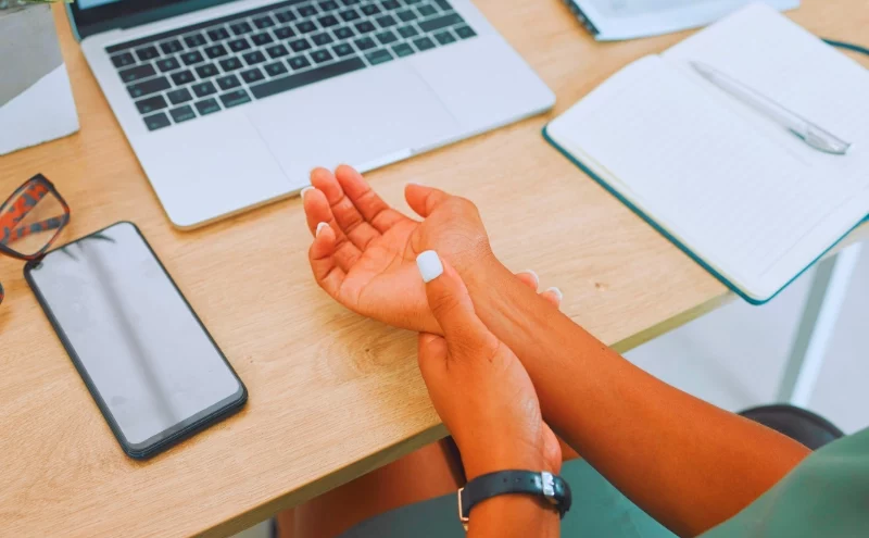 What Illinois Workers Should Know About Repetitive Stress Injuries 1 Wrist, arm and pain by laptop desk of employee worker suffering from carpal tunnel. Repetitive Stress Injuries