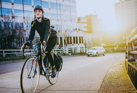A person riding a bicycle on a city sidewalk. Blocked Bike Lanes