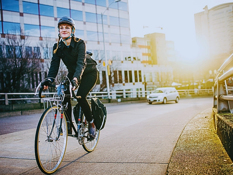 A person riding a bicycle on a city sidewalk. Blocked Bike Lanes