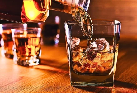 Whiskey and natural ice on old wooden table. Dram Shop Claims After a DUI Crash
