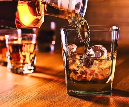 Whiskey and natural ice on old wooden table. Dram Shop Claims After a DUI Crash