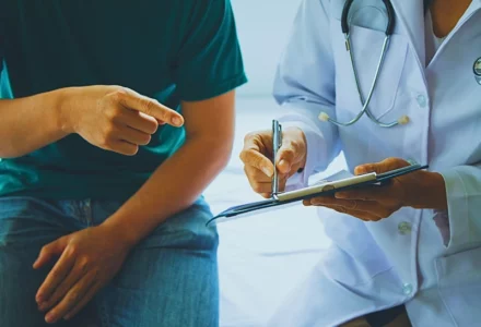 A doctor showing the medical report to her patient. Your Own Doctor for a Workers’ Comp Claim