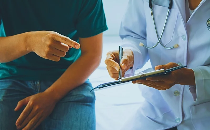 A doctor showing the medical report to her patient. Your Own Doctor for a Workers’ Comp Claim