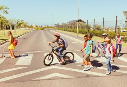 Group of school children crossing the street at a crosswalk.