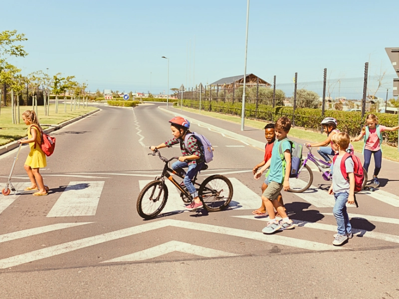 Group of school children crossing the street at a crosswalk.