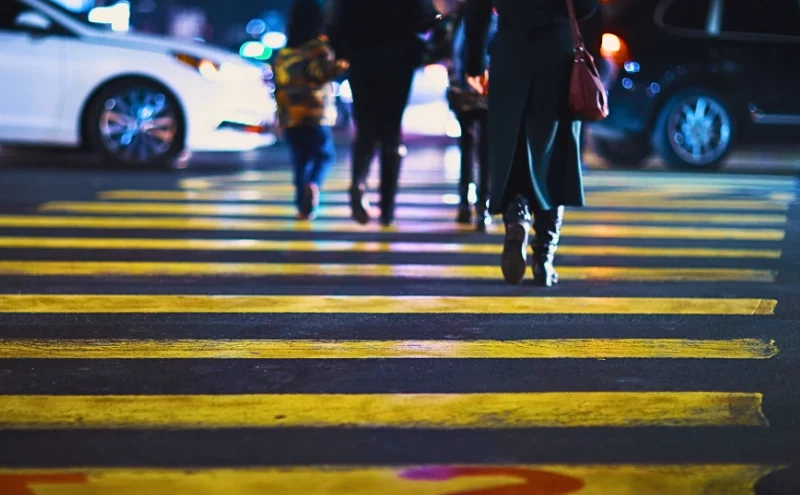What Makes Downtown Naperville a Hotspot for Pedestrian Accidents? 1 Pedestrians walking across a yellow crosswalk on a city street. downtown Naperville