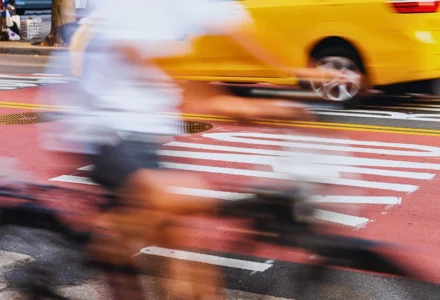 Blurred motion shot of a cyclist riding past a bus.