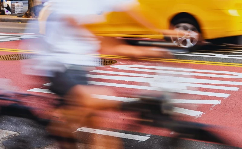 Who Pays After a Child Is Injured in an Illinois Hit-and-Run Crash? 1 Blurred motion shot of a cyclist riding past a bus.